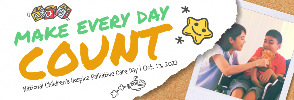 Pinned to a cork board, a piece of paper reads: Make Every Day Count - National Children's Hospice Palliative Care Day, October 13th, 2022. Beside it, a polaroid image of a mother playing with a teddy bear with her son who is sitting in a wheelchair is also pinned to the corkboard.