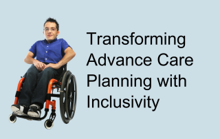 A man with spiky black hair and glasses sitting in a wheelchair.